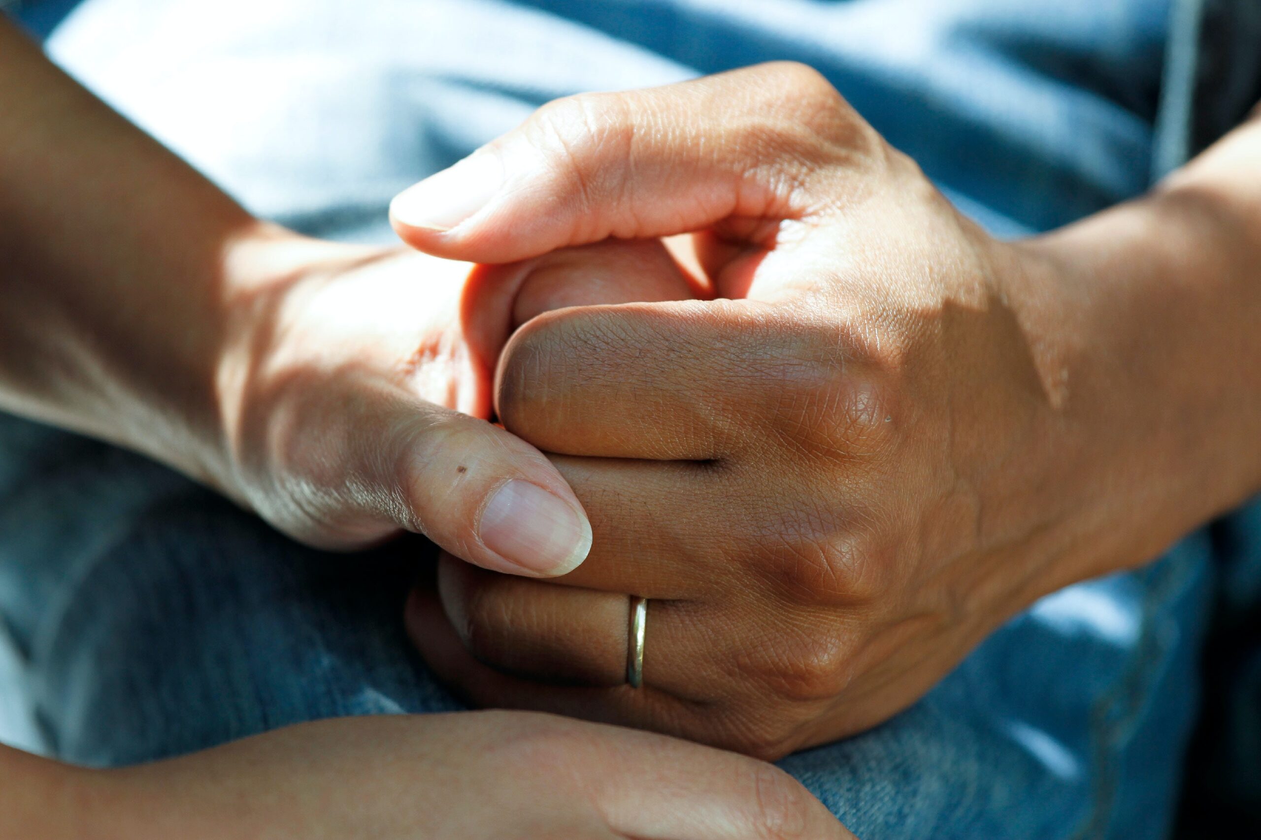 closeup of two hands embracing to indicate support for PTSD from a car accident