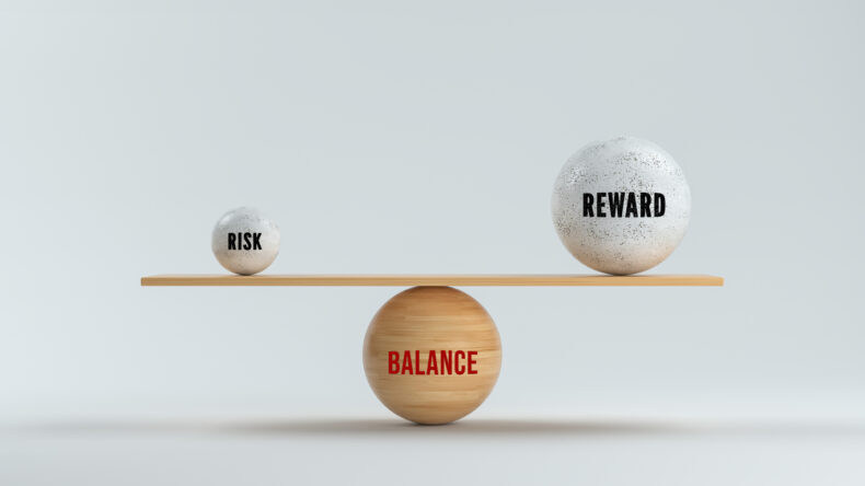 Concept of balancing Reward versus Risk in business and life with three spheres with text arranged as a see-saw in balance over a grey background - 3d illustration